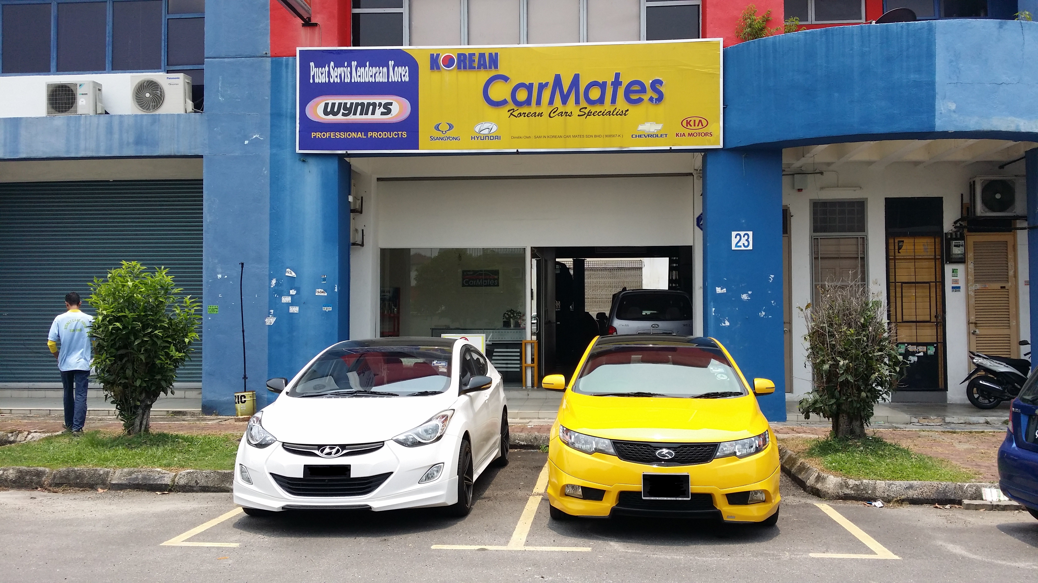 Workshop front with parked cars